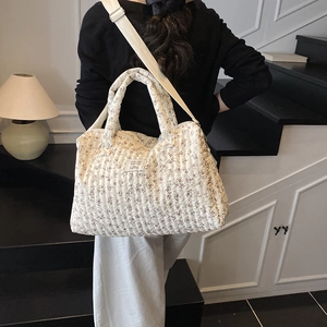 Quilted floral diaper tote bag with adjustable strap shown on model in home interior