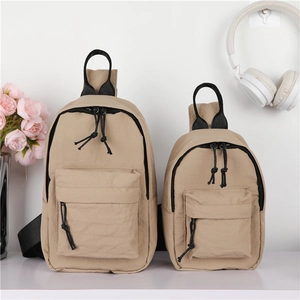 Détail de sacs de poitrine en nylon kaki de deux tailles avec fermetures éclair noires