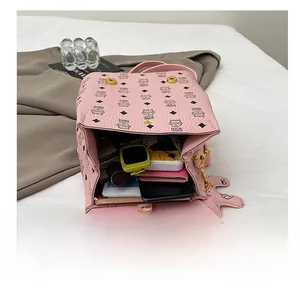 Internal view of pink faux leather backpack showing spacious storage and cat pattern