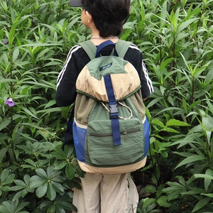 Multicolor outdoor backpack with drawstring closure and buckle flap in forest tones