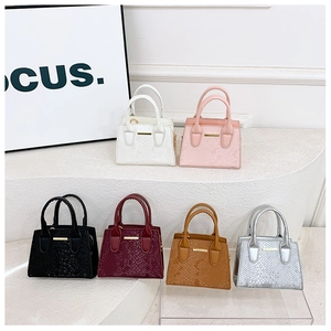 Detail of six mini tote bags in various colors featuring embossed faux snake skin texture