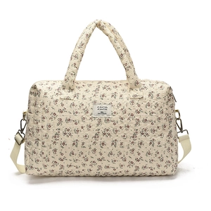 Quilted floral diaper bag with handles and adjustable strap for baby travel gear