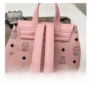 Detail view of the pink backpack featuring adjustable wide straps and cat pattern print
