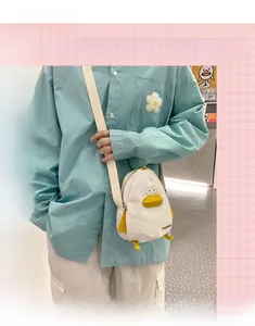 Detailed view of the cute white duck canvas crossbody bag worn by a 165cm tall model