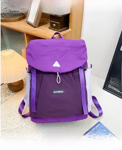 Detail of a purple outdoor backpack for kids showing buckle closures and side pocket