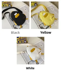 Three-color display of cute duck canvas crossbody bags in black, white and yellow