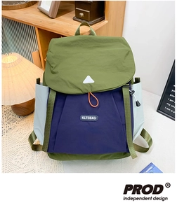 Detail of color-block kids backpack with olive and blue waterproof nylon fabric