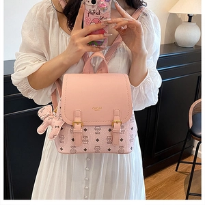Pink PU leather mini backpack featuring cute cat patterns and a plush bear pendant charm