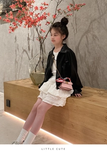 Detail of pink mini handbag with silk scarf handle and girls' leather jacket outfit