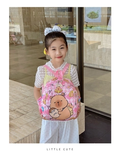Detailed view of pink checkered kids backpack with cute cartoon bear print on back