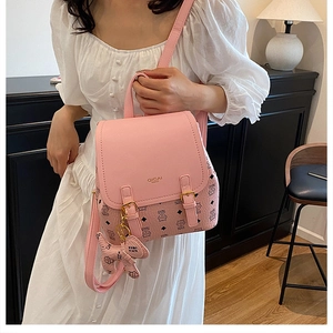 Pink PU leather backpack featuring cute cat prints, gold logo, and a cat charm detail