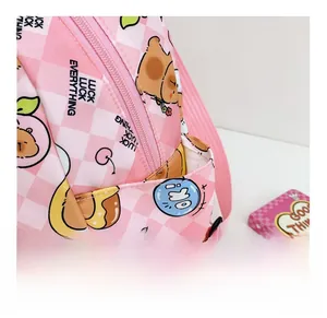 Detailed side pocket of pink cartoon backpack with cute bear and peach patterns