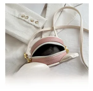 Top view of pink cartoon bear crossbody bag showing interior space for small cosmetics