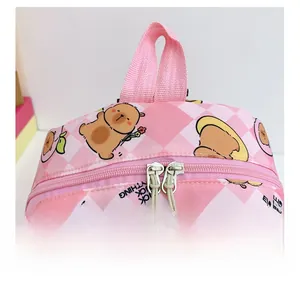 Detail of pink plaid kids backpack featuring a smooth zipper and Capybara print