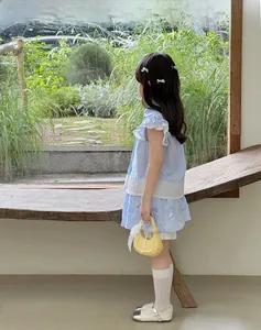 Ensemble fille avec haut à rayures bleues et jupe ornée de détails papillons colorés