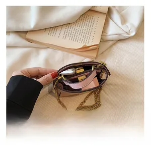 Detail view of pink mini chain bag showing interior compartments with lipstick storage