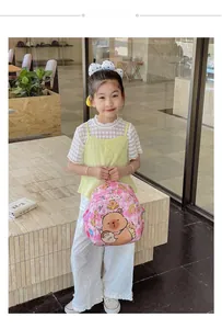 Close-up of pink checkered kids backpack with cartoon bear print and side mesh pocket