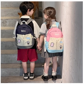 Detailed view of color-block children backpacks with Lucky patches on outdoor stairs
