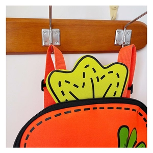 Close-up of bright orange carrot-themed kids backpack with cartoon patterns and handle
