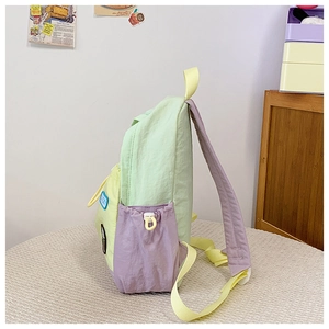 Detail view of colorful nylon kids backpack with side drawstring pocket and Lucky patch