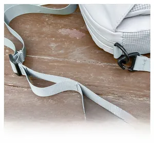 Detail of adjustable grey synthetic shoulder strap with black plastic buckle and swivel hook