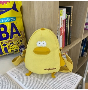 Detail of cute yellow duck canvas shoulder bag with embroidery eyes and 3D beak features