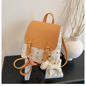 Detail of the chic contrast flap backpack with a cute dog pendant and stylish cat prints