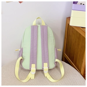 Close-up of pastel macaron color block backpack featuring durable canvas fabric details