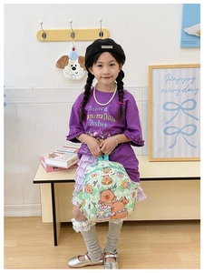 Girl carrying a lightweight green checkered backpack with cute bear and dessert patterns