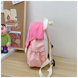 Detail view of pink kid backpack with mesh back, water bottle pocket and wing decor