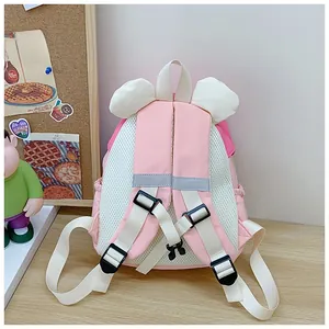 Detail of pink backpack featuring breathable mesh back and adjustable chest buckle strap