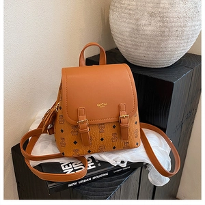 Detail of caramel PU leather backpack with cat print, diamond quilts and gold buckles