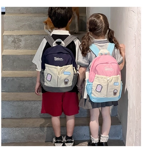 Contrast color kids backpack with drawstring front pocket and Lucky logo patch