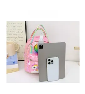 Pink sequin unicorn backpack showing size comparison with a tablet and smartphone