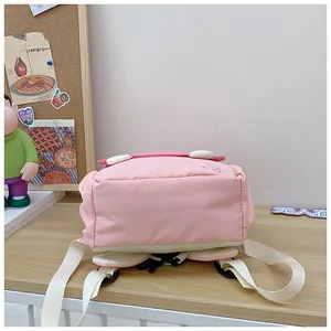 Detail of pink nursery backpack showing breathable mesh padding and adjustable straps