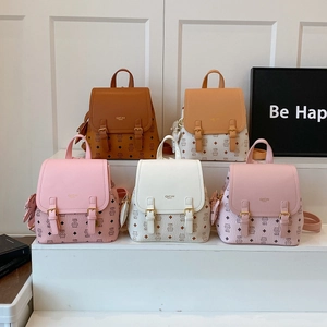 Close-up of mini backpacks in five colors featuring pebble leather and crown print
