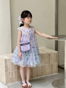 Detailed view of kids floral dress with lace collar and purple pleated crossbody bag