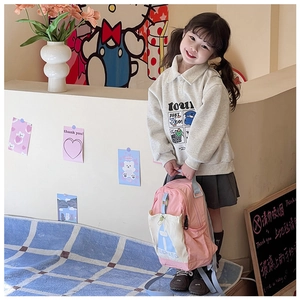 Pink and beige color-block kids backpack with soft straps worn by a young girl