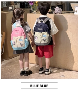 Detail of color-block kids backpacks featuring Tochaso embroidery and Lucky patch designs