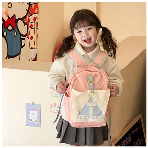 Detail of pink and cream kids backpack with TOCHASO lettering and adjustable straps