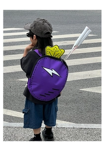 Outdoor view of purple cartoon carrot backpack with tennis racket storage and lightning logo