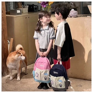 Close-up of stylish contrast color kids backpacks with embroidery and cute patches