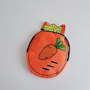 Detail of cute carrot-shaped kids backpack featuring green leaves and orange fabric texture