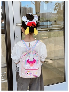 Toddler girl sequin unicorn backpack and mouse ears headband shown in a lifestyle setting