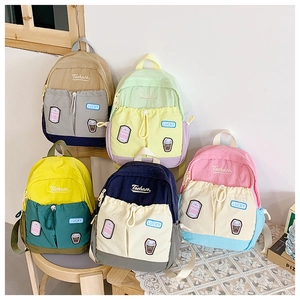 Detail of color-block kids backpacks with drawstrings and embroidery badges