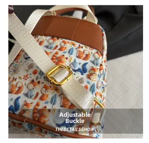 Detailed close-up of a gold metal adjustment buckle on a cute cartoon fox printed backpack