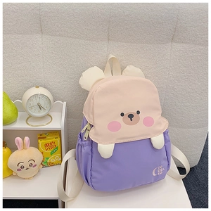Detail of cute purple cartoon bear backpack with brand embroidery for children