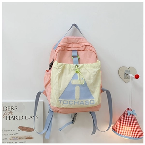 Detail of color-block canvas kids backpack featuring pink and beige panels with logo