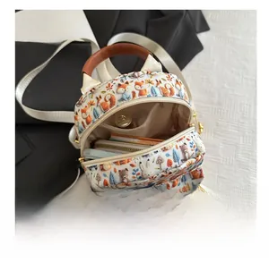 Detail view of mini cartoon backpack showing internal storage capacity and forest animal print