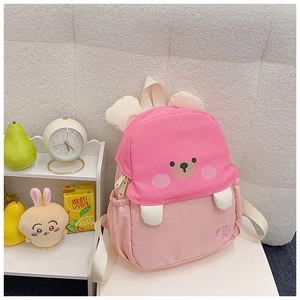 Detail view of pink bear-themed backpack featuring 3D ears and durable fabric